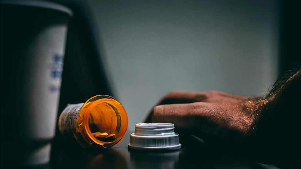 Orange and White Prescription Bottle On Table