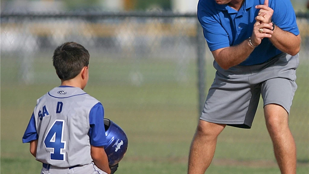 Man Kneeling on Baseball Field Beside Man