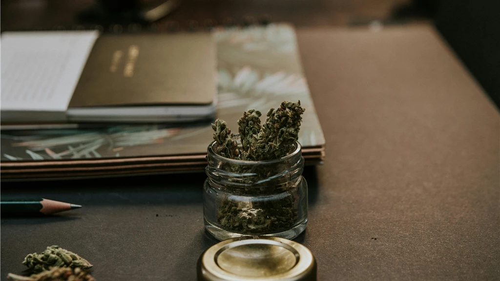 Close-Up Photo of Kush On Glass Container