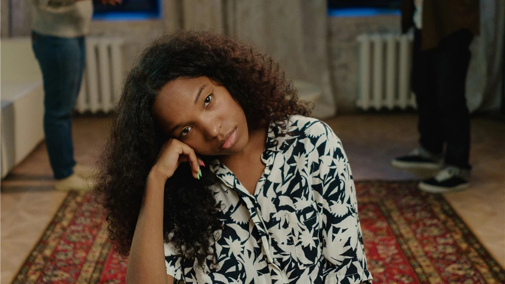 A Sad Young Woman Sitting on a Chair